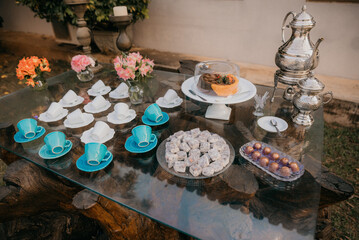Breakfast with colorful cups, cake and a beautiful old teapot