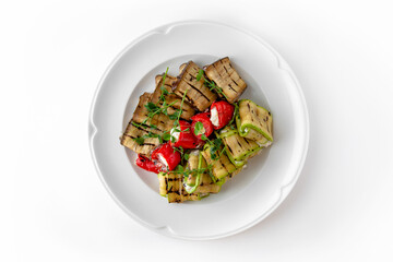 Envelopes of zucchini and eggplant stuffed with cheese, grilled vegetables with nuts and herbs on a...