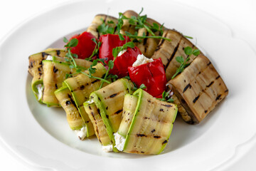 Envelopes of zucchini and eggplant stuffed with cheese, grilled vegetables with nuts and herbs on a...