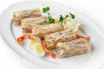 Jellied chicken and turkey on a white plate. Banquet festive dishes. Gourmet restaurant menu. White background.