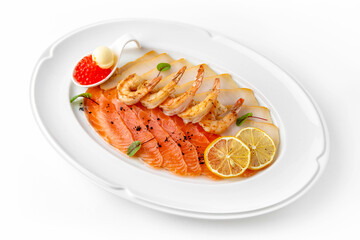 Plate with appetizer of fish and seafood. Sliced salted fish fillet. Smoked salmon, perch, prawn. Banquet festive dishes. Gourmet restaurant menu. White background.