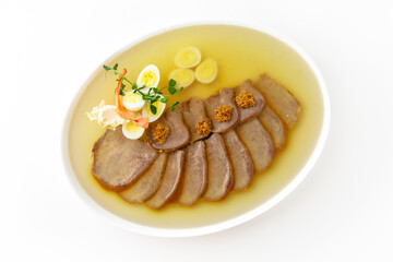 Beef tongue jelly on a white plate. Banquet festive dishes. Gourmet restaurant menu. White...