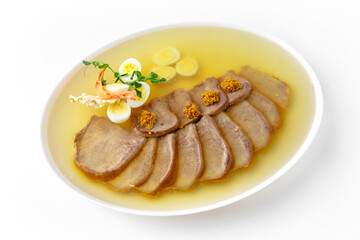 Beef tongue jelly on a white plate. Banquet festive dishes. Gourmet restaurant menu. White background.