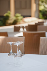 Clean glass goblets on a table in a summer cafe 