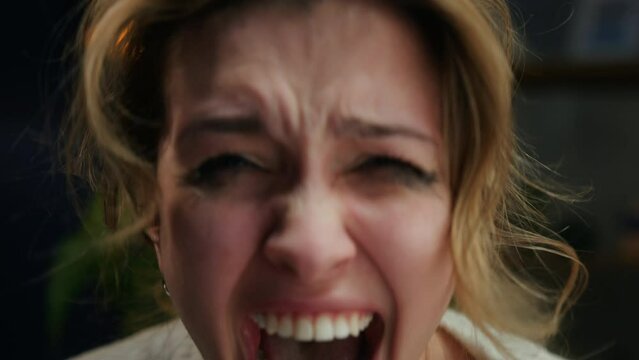Crying woman shouting, portrait of screaming female person in living room, feeling anger and stress, bad mood. Family problems, aggressive emotional wife quarreling. 
