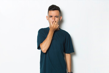 man holding his nose because of a bad smelling something
