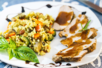Dinner of roast meat, gravy and savory rice
