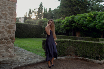 Young beautiful model in black dress and with sunglasses