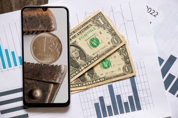 The gas key holds the Russian ruble as a background in the phone and dollars lie nearby, the...