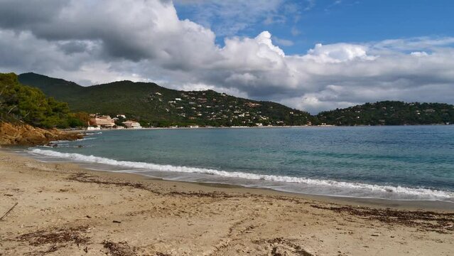 View of beach Plage du Layet at the rocky mediterranean coast near town Le Lavandou at the French Riviera, France on sunny day in autumn season with small waves.