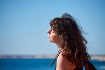 Naklejka premium A portrait of a young Caucasian girl on the beach in Spain