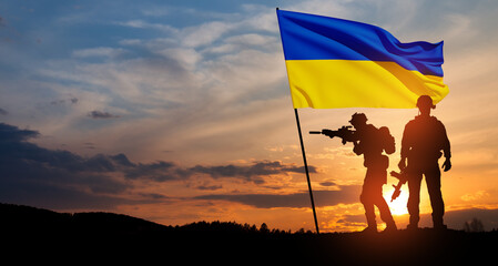 Flag of Ukraine with silhouette of soldiers against the sunrise or sunset. Concept - armed forces of Ukraine. Relationship between Ukraine and Russia.