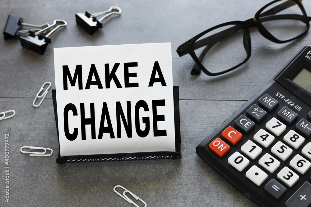 Poster make a change . text on a business card on a stand. gray table
