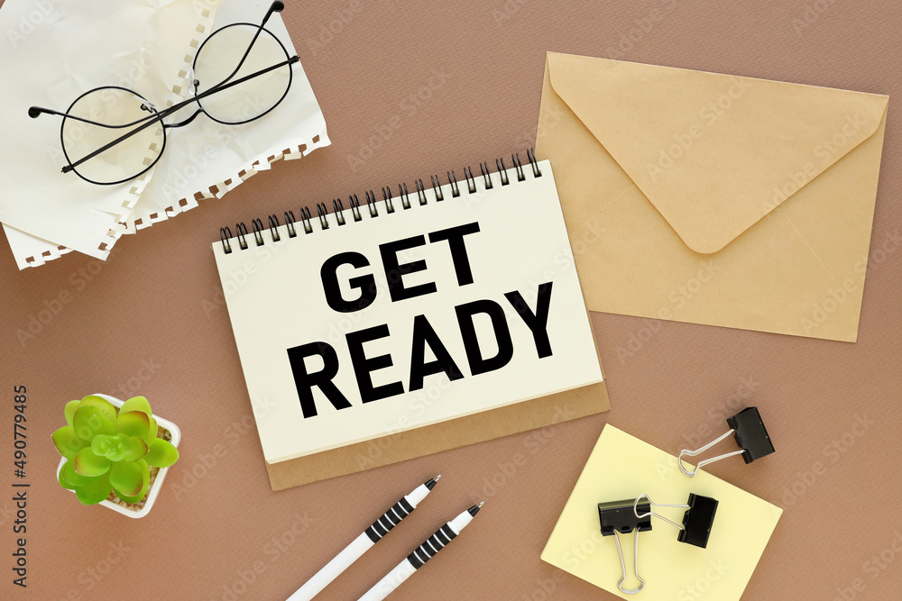 Poster get ready. open notepad with text, keyboard, pen, keyboard on brown background spiral notepad on tab