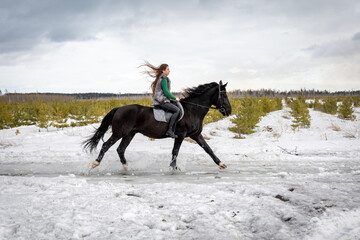 girl rides a horse. Walk with a horse through the countryside. fast jump