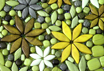 Flower petals and a background of gray, yellow, brown, white and green stones