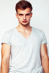 Obraz premium young handsome teenage hipster guy posing emotional, happy smiling against white background isolated, lifestyle people concept