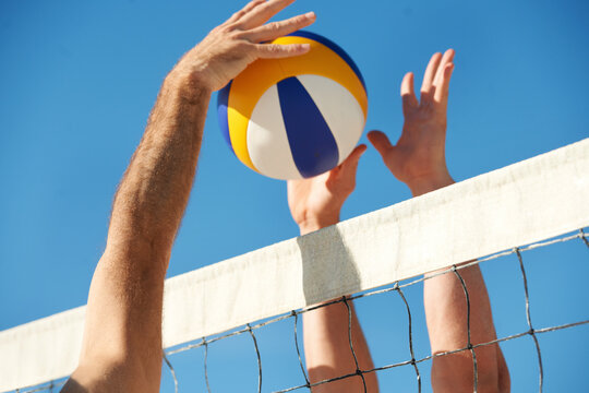 Its anyones point now. Shot of a beach volleyball game on a sunny day.