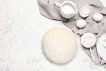 Raw dough with ingredients on light background