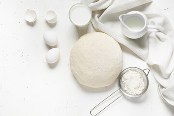 Obraz na płótnie Canvas Raw dough with ingredients on light background