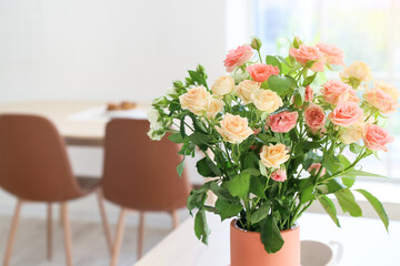 Vase with beautiful roses in kitchen, closeup