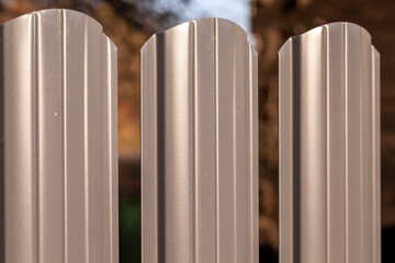 the upper part of a metal fence painted with gray paint