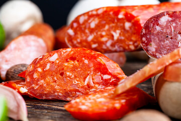 sliced pieces of sausage from meat are lying on a cutting board