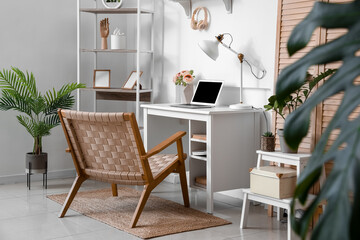 Interior of light office with modern workplace and shelving unit