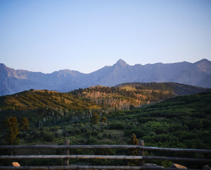 Fototapeta na wymiar Sunset light shining on hillside in front of Rocky Mountains