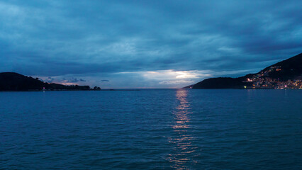 Sunset over the sea with islands stretching into the distance