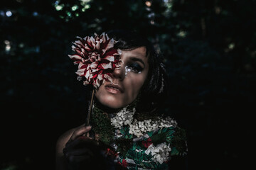 Dryad covered with a pattern of bones and flowers in the forest