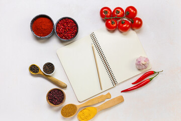 Blank notebook, spices and vegetables on light background