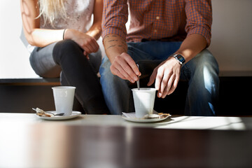 They love their coffee. Cropped image of a young couple enjoying coffee at their local cafe.