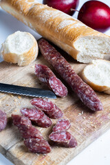 sliced pieces of sausage from meat are lying on a cutting board