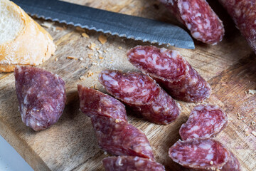 sliced pieces of sausage from meat are lying on a cutting board