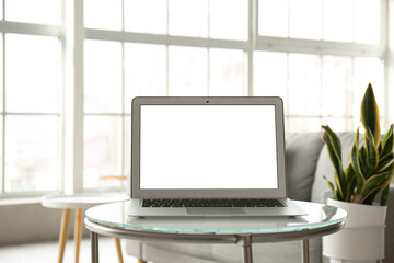 Fototapeta premium Modern laptop on glass table in light room