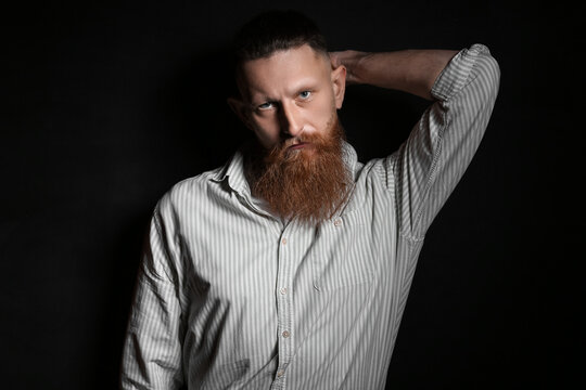 Portrait of handsome bearded man on dark background