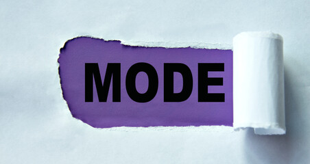MODE - word on a purple background and torn white paper