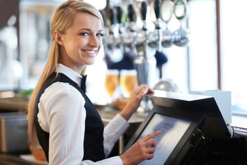 I am a whiz on this till. Beautiful barmaid standing by a till smiling as she rings through a round...