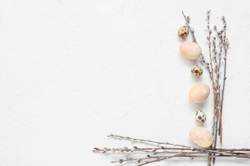 Composition with Easter eggs and pussy willow branches on light background
