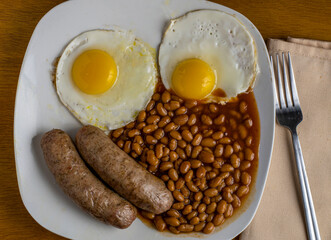 two eggs sausage with baked beans