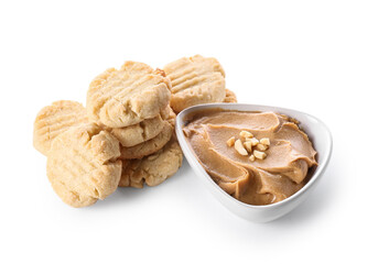 Tasty peanut cookies and bowl with butter on white background