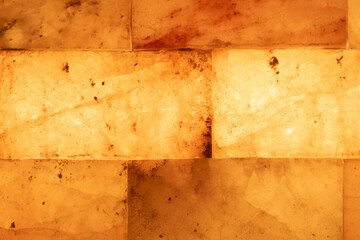 Salt bricks close up. Illuminated salt bricks in the sauna, background, texture