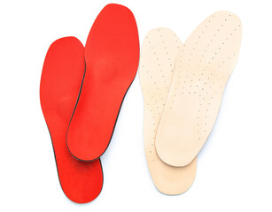 Two pairs of orthopedic insoles on white background