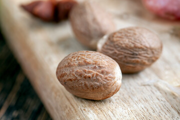 a whole nutmeg on a wooden board