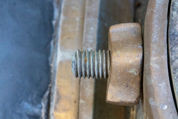 Photograph of a threaded copper bolt and nut