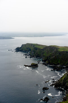 Vertical aerial view of the island in the ocean on a foggy day