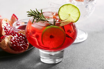 Glass of tasty pomegranate cocktail on table