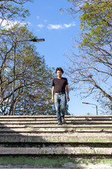 guatemalan man walking downstairs in a park outdoors