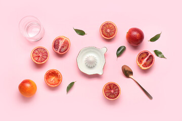 Ceramic juicer and grapefruits on pink background